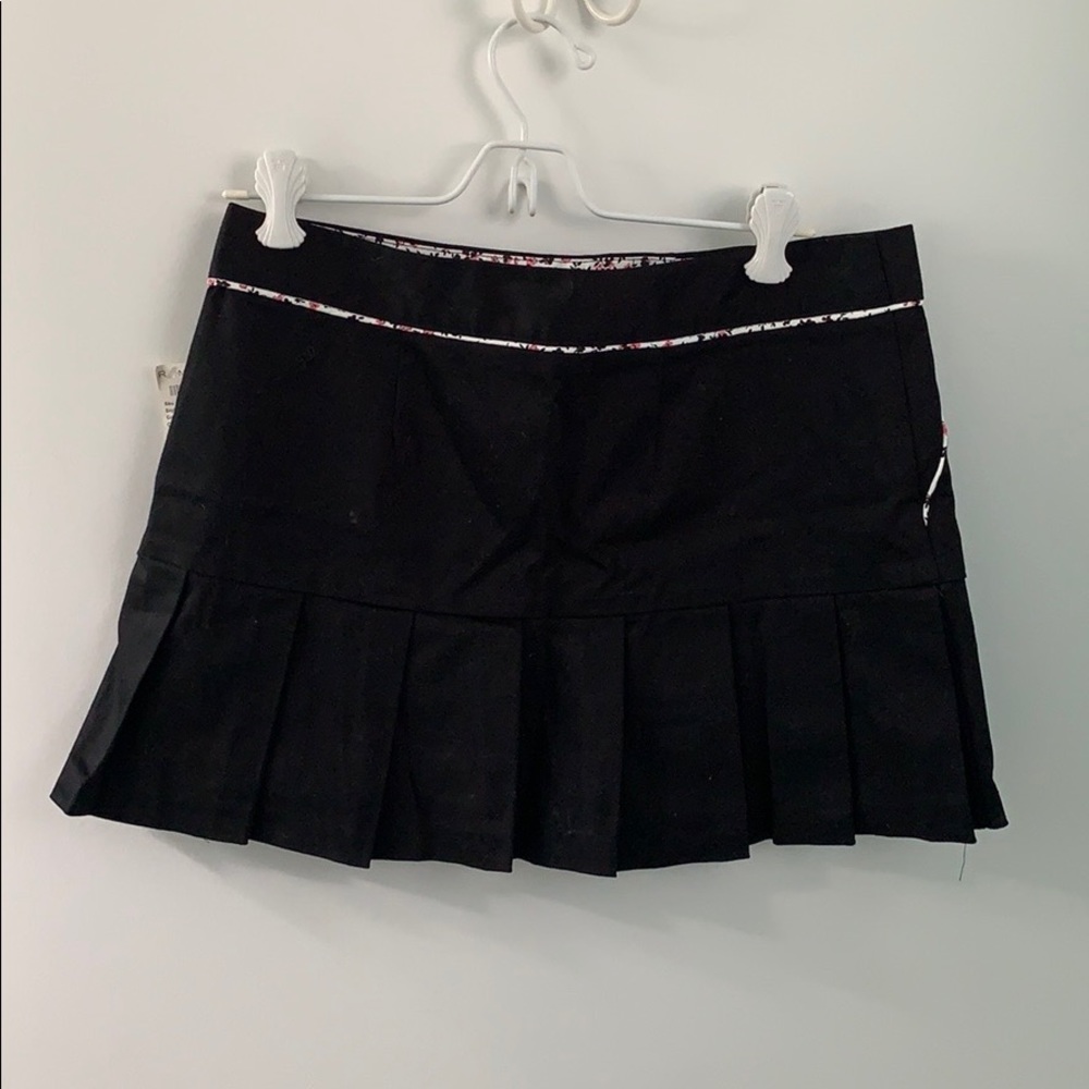 Black pleated skirt with floral trim
